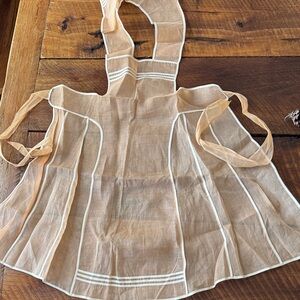 Vintage peachy colored Apron with cream  Trim. Good shape for age